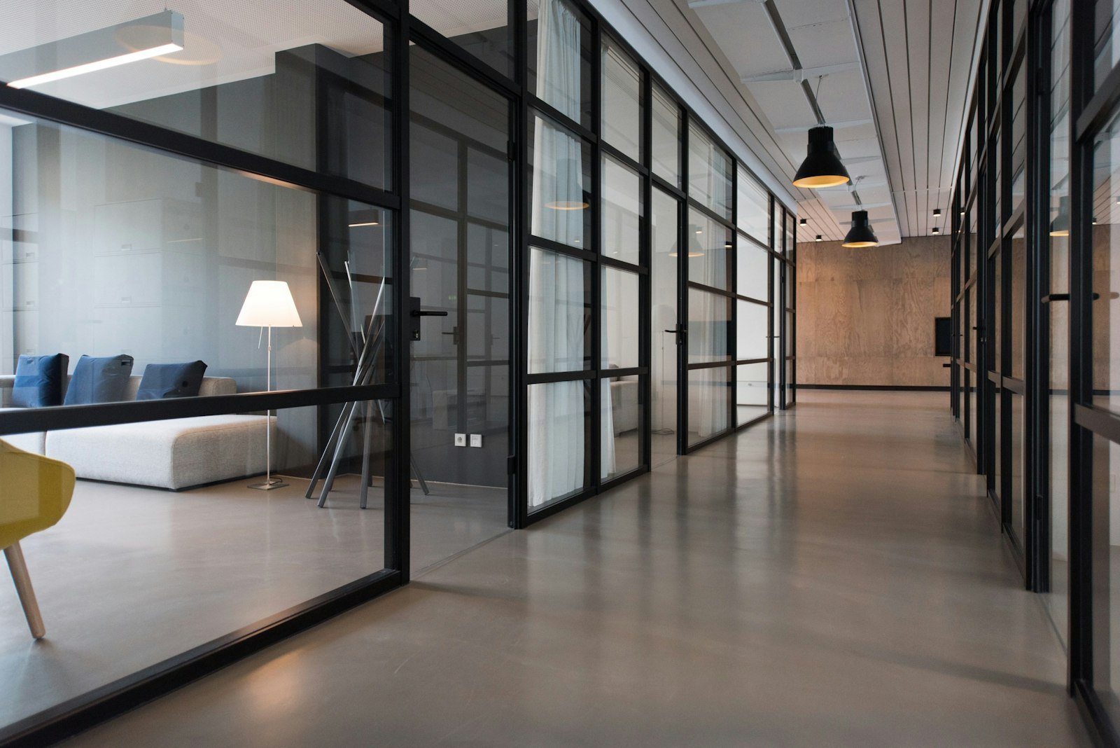 Commercial suspended ceiling grid over an open-plan workplace with coordinated lighting positions.